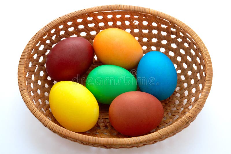 Easter painted eggs in webbed wooden plate stock image